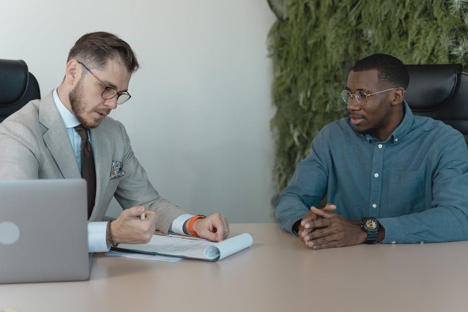 pexels-photo-5439436-5439436 A professional job interview between two men in a modern office environment.